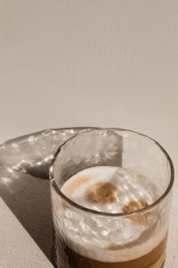 Kaboompics - Top Down Latte Cup with Sunlit Reflections on Stone