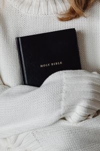 Kaboompics - Holy Bible Resting in a White Knit Sweater, Close-Up