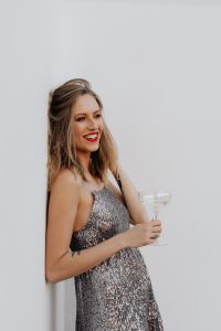 Kaboompics - Three-Quarter Portrait with Champagne Flute in Silver Sequin Dress
