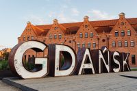 Kaboompics - Large Gdańsk City Sign in Front of Historic Brick Waterfront Granary