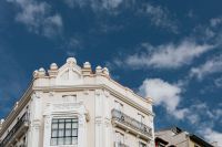 Kaboompics - Madrid Historic Facade Framed Below Deep Blue Cloud-Streaked Sky, Wide Architecture View