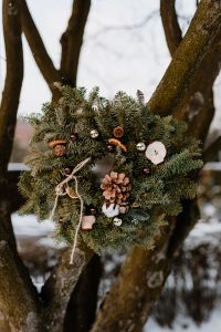 Kaboompics - Natural Christmas Wreath Hanging on a Snowy Tree
