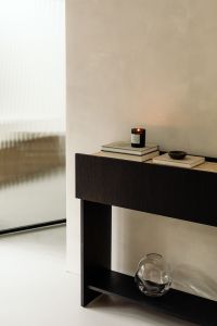 Kaboompics - Lit Candle on Books and Dark Bowl on Travertine Console