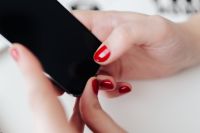 Kaboompics - Businesswoman uses her mobile phone at her desk