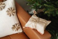 Kaboompics - Fabric Gift Pouch and Wooden Snowflakes on Sofa