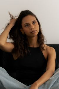 Kaboompics - Woman Touching Hair in Seated Studio Portrait