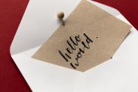 Kaboompics - Kraft Card in White Envelope on Red Background Close-Up