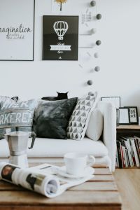 Modern Black-and-White Living Room Decor with Magazines, Coffee Table Styling and Graphic Wall Art
