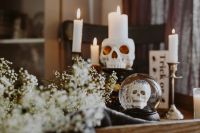 Kaboompics - Halloween Skull Candle and Crystal Skull Ball with Baby's Breath