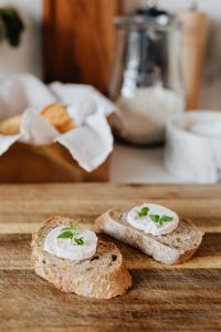 Kaboompics - Honey Jar and Baguette Slices in a Warm Kitchen Setting