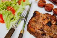 Kaboompics - Landscape Grilled Pork Neck Plate with Fresh Salad and Cherry Tomato, Summer Barbecue Meal
