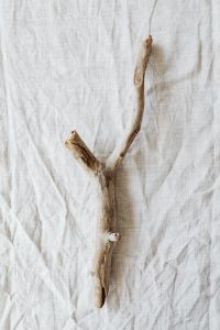 Kaboompics - Single Forked Driftwood Branch on White Linen, Minimal Neutral Background