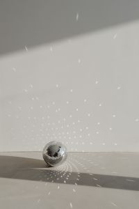 Kaboompics - New Year's Eve Party Background with Disco Ball Reflections and Copy Space
