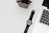 Kaboompics - Black Watch Beside MacBook Keyboard on a Bright Desk