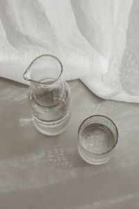 Kaboompics - Overhead Minimal Water Glassware Arrangement Beside Linen Curtains