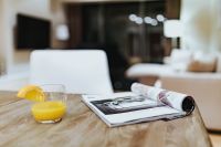 Kaboompics - Magazine with a fresh juice on a table