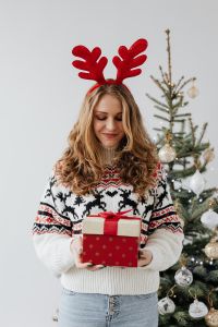 Kaboompics - Woman in Reindeer Antlers Holding a Red Christmas Gift