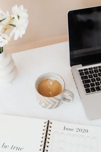 Kaboompics - Laptop, Coffee and Be True to You Planner with White Flowers