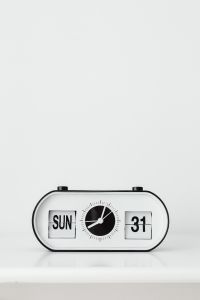 Kaboompics - Retro Black and White Flip Desk Clock with Day and Date Display on White Background