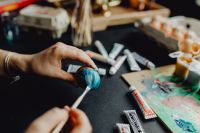 Kaboompics - Woman Painting Blue Easter Eggs