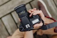 Kaboompics - Photographer holding a DSLR camera