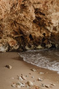 Kaboompics - Rocky Sea Cave And Sandy Beach With Gentle Waves