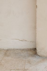 Kaboompics - Minimal White Plaster Wall Corner with Weathered Stone Floor