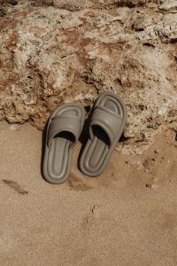 Kaboompics - Beige Slides Beside a Rugged Coastal Rock