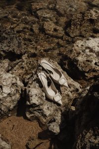 Kaboompics - White Pointed-Toe Pumps in an Overhead Pebble-Shore View