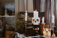 Kaboompics - Halloween Skull Candle Arrangement with Candles and Vanilla Bean Candle