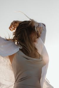 Kaboompics - Faceless Woman Looking at Ocean in White Shirt
