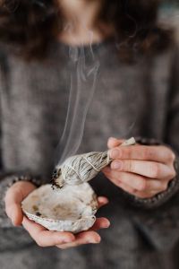Kaboompics - Thin Smoke Rising over a Shell against a Gray Knit Background, Ritual Detail