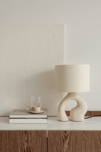 Kaboompics - Coffee Cup and Glass Beside a Sculptural Ceramic Table Lamp, Neutral Interior