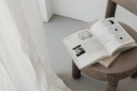 Kaboompics - Beige Upholstered Chair with Open Books and Sheer Curtain