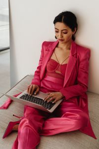 Kaboompics - Woman in Pink Satin Suit Working from Sofa