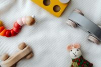 Kaboompics - Wooden Toy Cars and Handmade Mouse Doll on a Soft Play Blanket