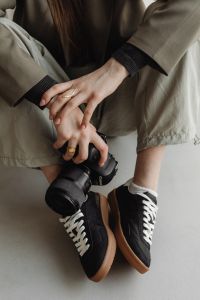 Kaboompics - DSLR Camera Over Black Sneakers in Young Photographer Outfit