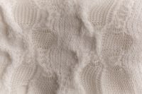 Kaboompics - Cream Textured Knit Fabric in Soft Natural Folds