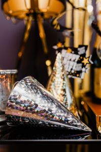 Kaboompics - Vertical Silver Party Horn and Gold Party Hat with Champagne Decor