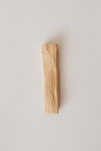 Kaboompics - Single Unburned Palo Santo Stick on Beige Background with Copy Space