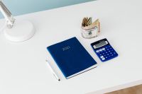 Kaboompics - Financial Planning Flat Lay with 2021 Diary, Dollars and Calculator
