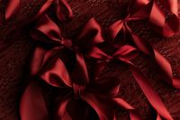 Kaboompics - Red Gift Boxes with Bows on Textured Dark Background