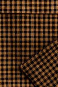 Kaboompics - Amber Gingham Fabric Folded – Check Textile Close-Up