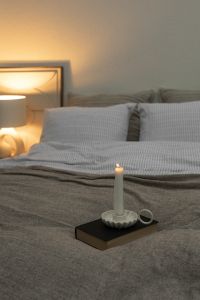 Kaboompics - Lit Candle on a Cozy Bed
