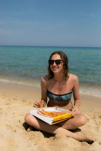 Kaboompics - Seated Woman with a Pizza Box by the Sea