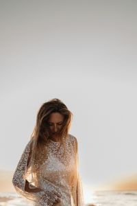 Kaboompics - Woman in Sequin Dress Standing by the Sea at Golden Hour