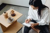 Kaboompics - Woman Writing Morning Notes Beside Coffee and Chemex