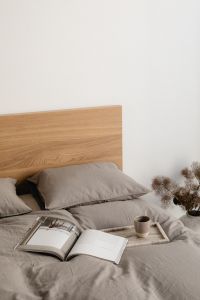 Kaboompics - Coffee and Open Books on a Cozy Gray Bed