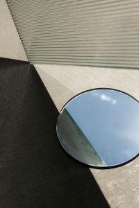 Kaboompics - Minimalist Geometric Background with Round Mirror and Gray Panels