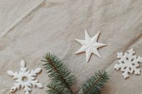Kaboompics - Wide Natural Linen Christmas Background with White Stars, Snowflakes and Evergreen Branches